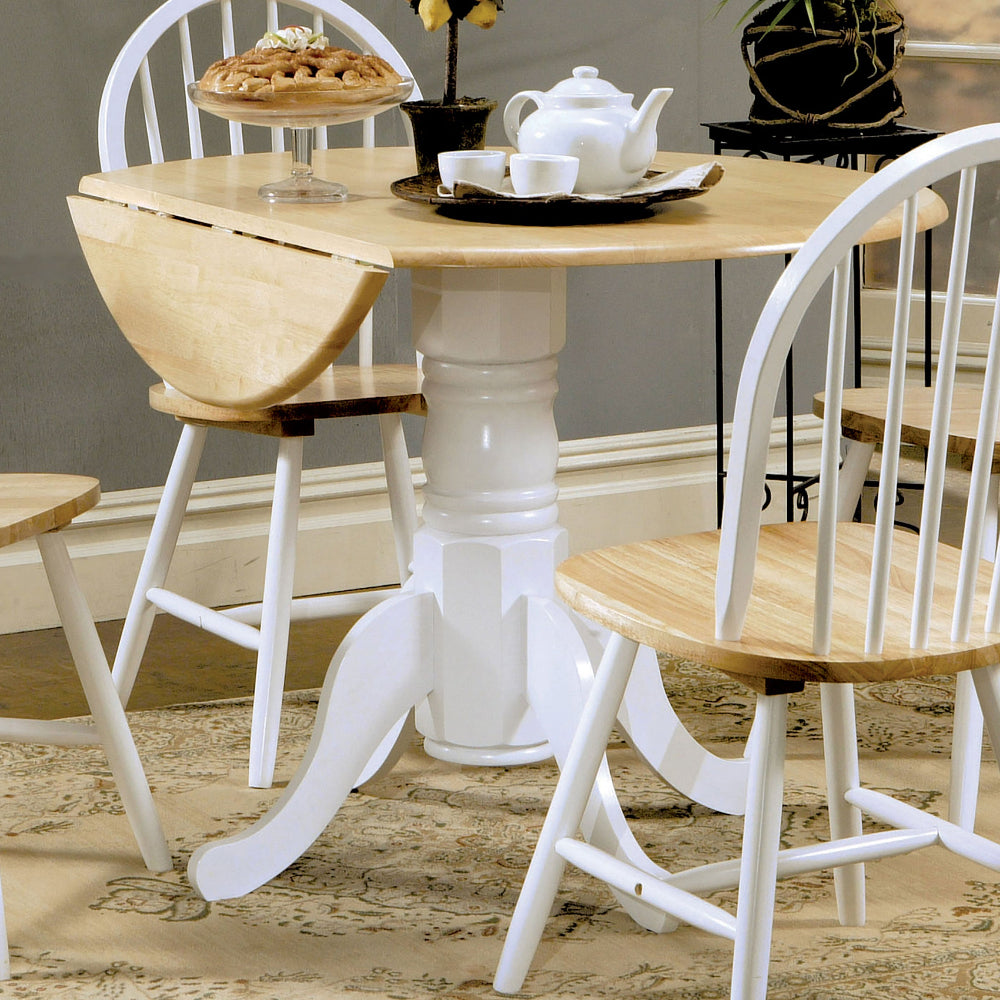 Dining room with a wooden table and chairs, including a teapot and cup.