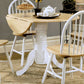 Dining room with a wooden table and chairs, including a teapot and cup.