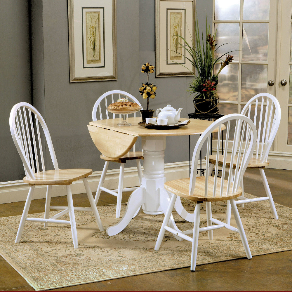 Dining room with a wooden table and chairs on a beige rug.