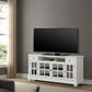 White TV stand with a black television in a living room setting. with dimensions