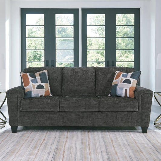 Gray sofa with patterned cushions in a living room setting
