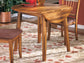 Wooden dining table with chairs on a patterned rug