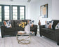 Living room with gray sofa and loveseat, a coffee table, and decorative items.