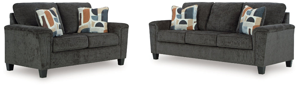 gray sofa and loveseat with patterned cushions on a white background