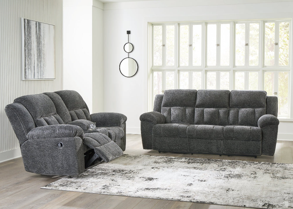 Gray sofa set in a living room with large windows