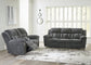 Gray sofa set in a living room with large windows